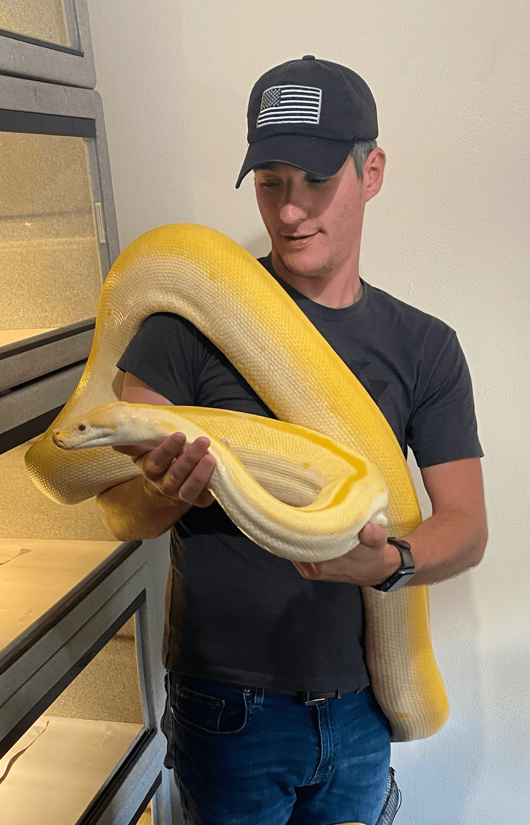 Jonathan, owner of Castle Reptiles and lead developer of Scutely, holding an albino reticulated python